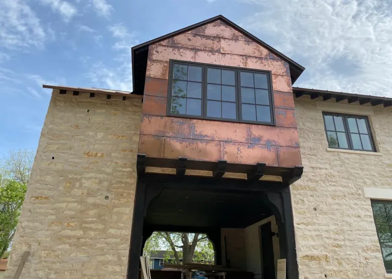 Copper metal panel facade on a stone building for Roof Repair in Upper Deerfield